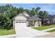 Charming home features a well-manicured lawn, a two-car garage, and a welcoming front entrance at 301 Retreat Way, Carrollton, GA 30116