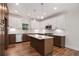 Modern kitchen features granite counters, stainless steel appliances, white and brown cabinets, and central island at 301 Retreat Way, Carrollton, GA 30116