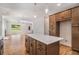 Bright kitchen showcasing hardwood floors, granite countertops, stainless steel appliances, and center island at 301 Retreat Way, Carrollton, GA 30116