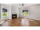 Bright and airy living room features hardwood floors, a modern ceiling fan, and a cozy fireplace at 301 Retreat Way, Carrollton, GA 30116