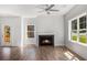 Bright and airy living room features hardwood floors, a modern ceiling fan, and a cozy fireplace at 301 Retreat Way, Carrollton, GA 30116