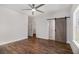 Main bedroom showcases a barn door to the bath, wood floors, and walk in closet at 301 Retreat Way, Carrollton, GA 30116