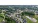 Aerial view of homes nestled within a scenic community with a pond and verdant landscape at 6415 Yellow Birch St, Cumming, GA 30040