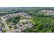 Scenic aerial shot of a residential area featuring a pond, mature trees, and well-maintained properties at 6415 Yellow Birch St, Cumming, GA 30040