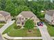 Gorgeous two-story home with a luscious front lawn, long driveway, and brick and siding facade at 6415 Yellow Birch St, Cumming, GA 30040