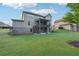 Lush green backyard with a covered deck overlooking the yard and a walk out patio space at 6415 Yellow Birch St, Cumming, GA 30040
