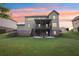 Exterior view highlighting the home's backyard, covered deck, and patio area with outdoor seating at 6415 Yellow Birch St, Cumming, GA 30040