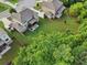 Aerial shot showcases a green backyard, a covered deck, and a patio with outdoor seating at 6415 Yellow Birch St, Cumming, GA 30040