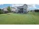 Expansive backyard showcasing lush green grass, a covered back deck, and a patio area at 6415 Yellow Birch St, Cumming, GA 30040