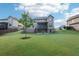 Lush backyard featuring a covered deck with steps down to the patio at 6415 Yellow Birch St, Cumming, GA 30040