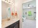Attached bathroom features marble countertops and modern light fixtures to brighten your morning at 6415 Yellow Birch St, Cumming, GA 30040