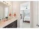 Attached bath features marble countertops and modern light fixtures to brighten your morning at 6415 Yellow Birch St, Cumming, GA 30040