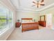 Spacious primary bedroom with tray ceilings, fan, and large windows for natural light at 6415 Yellow Birch St, Cumming, GA 30040