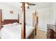 This primary bedroom features a four-poster bed and a ceiling fan for air circulation at 6415 Yellow Birch St, Cumming, GA 30040