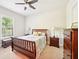 Cozy bedroom featuring a ceiling fan, carpet, and furniture made from mahogany at 6415 Yellow Birch St, Cumming, GA 30040
