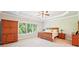 Spacious bedroom with tray ceilings, fan, and large windows for natural light at 6415 Yellow Birch St, Cumming, GA 30040