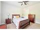 Cozy bedroom featuring a ceiling fan, carpet, and furniture made from mahogany at 6415 Yellow Birch St, Cumming, GA 30040