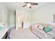 Bedroom area featuring a doorway to the bathroom, a large couch and desk at 6415 Yellow Birch St, Cumming, GA 30040