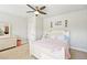 Bright bedroom features a ceiling fan, dresser, and large window for ample natural light at 6415 Yellow Birch St, Cumming, GA 30040