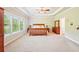 Spacious primary bedroom with tray ceilings, fan, and large windows for natural light at 6415 Yellow Birch St, Cumming, GA 30040
