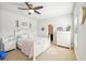 Inviting bedroom with a ceiling fan, a neutral color scheme, and bright natural light at 6415 Yellow Birch St, Cumming, GA 30040