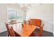 Formal dining room featuring a wooden table, matching chairs, and natural light at 6415 Yellow Birch St, Cumming, GA 30040