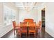 Elegant dining room with coffered ceiling, chandelier, and hardwood floors at 6415 Yellow Birch St, Cumming, GA 30040