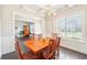 Classic dining room with coffered ceiling, wooden furniture, and large window at 6415 Yellow Birch St, Cumming, GA 30040