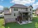 Picture of the back exterior showing a covered deck and cozy patio in a lush, landscaped backyard at 6415 Yellow Birch St, Cumming, GA 30040