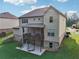 The home's exterior shows a covered deck and patio with seating in a well-maintained backyard at 6415 Yellow Birch St, Cumming, GA 30040