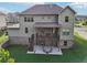 Exterior shot features the home's covered deck, patio, landscaped lawn, and charming architectural details at 6415 Yellow Birch St, Cumming, GA 30040