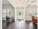 Bright, open foyer showcases hardwood floors, natural light, and a view of the formal dining room at 6415 Yellow Birch St, Cumming, GA 30040
