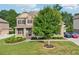Beautiful brick home with a well-manicured lawn and mature landscaping creating great curb appeal at 6415 Yellow Birch St, Cumming, GA 30040