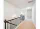 Neutral color hallway with wood handrail, carpet, and white colored walls at 6415 Yellow Birch St, Cumming, GA 30040
