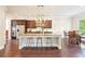 Bright open kitchen with granite counters, a center island with seating, and stainless steel appliances at 6415 Yellow Birch St, Cumming, GA 30040