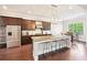 Open kitchen with stainless appliances, a center island with stool seating, and a breakfast nook at 6415 Yellow Birch St, Cumming, GA 30040