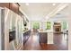 Kitchen with stainless steel appliances and an open concept view to the living room at 6415 Yellow Birch St, Cumming, GA 30040