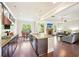 Open-concept kitchen with an island, stainless steel appliances, and views into the living area at 6415 Yellow Birch St, Cumming, GA 30040