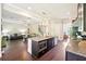 Open-concept kitchen flowing into the living room, featuring an island with stainless appliances at 6415 Yellow Birch St, Cumming, GA 30040