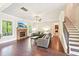 Spacious living room features a fireplace, hardwood floors, and staircase access at 6415 Yellow Birch St, Cumming, GA 30040