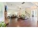 Bright and airy living room featuring a fireplace, hardwood floors, and neutral decor at 6415 Yellow Birch St, Cumming, GA 30040