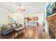 Open-concept living room showcasing a stone fireplace and seamless transition to the kitchen at 6415 Yellow Birch St, Cumming, GA 30040