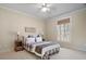 Bedroom features a window, carpet, ceiling fan, and a bed with gray and red plaid covers at 216 Crescent Moon Way, Canton, GA 30114