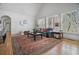 Bright living room with hardwood floors, plantation shutters, and seamless access to dining area at 216 Crescent Moon Way, Canton, GA 30114
