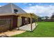 Backyard features a covered patio, privacy fence, green grass, and mature trees at 337 Inverness Ave, Mcdonough, GA 30253