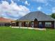 Charming brick home featuring a delightful pergola-covered patio and a lush green lawn at 337 Inverness Ave, Mcdonough, GA 30253
