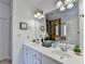 Bright bathroom features a double vanity, framed art, decor, and a large mirror at 337 Inverness Ave, Mcdonough, GA 30253