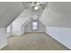 Spacious carpeted bonus room features slanted ceilings and a ceiling fan at 337 Inverness Ave, Mcdonough, GA 30253