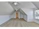 Spacious carpeted bonus room with an open door features slanted ceilings and 3 ceiling fans at 337 Inverness Ave, Mcdonough, GA 30253