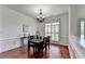 Dining area featuring hardwood floors, classic wainscoting and natural light from large windows at 337 Inverness Ave, Mcdonough, GA 30253